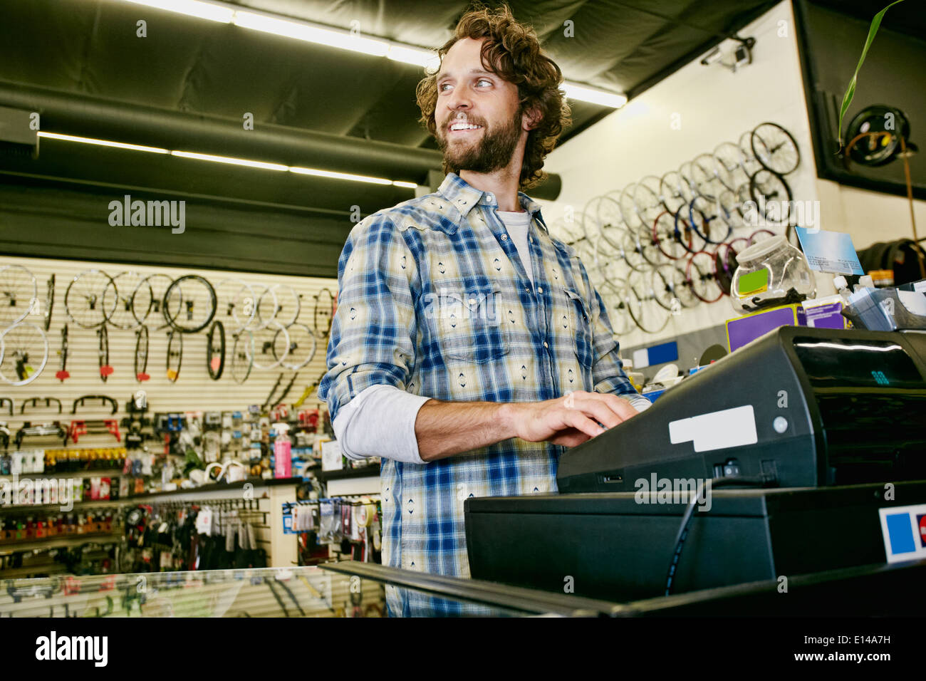 Caucasian man working in bicycle shop Stock Photo