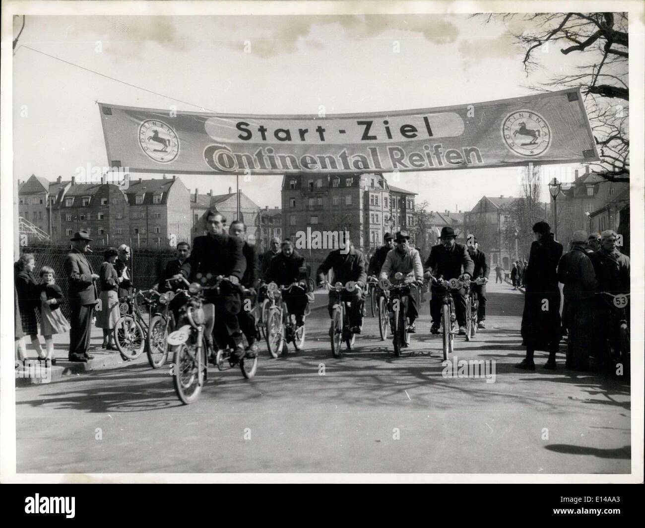 Apr. 17, 2012 - Racing of bicycles with motor. The first German Race of bicycles with motors was held in Nuremberg on the occasion of the special show at the ''Day of the Bicycle''. It was a reliability-run over 70 kilometers. Our picture shows the arrival of the first drivers on the winning-post . In front a tandem-bicycles with the blind Mr. Schaffner, Nuremberg, on the backseat. Behind him Mrs. Herbst who was the only woman taking part in the race. Stock Photo