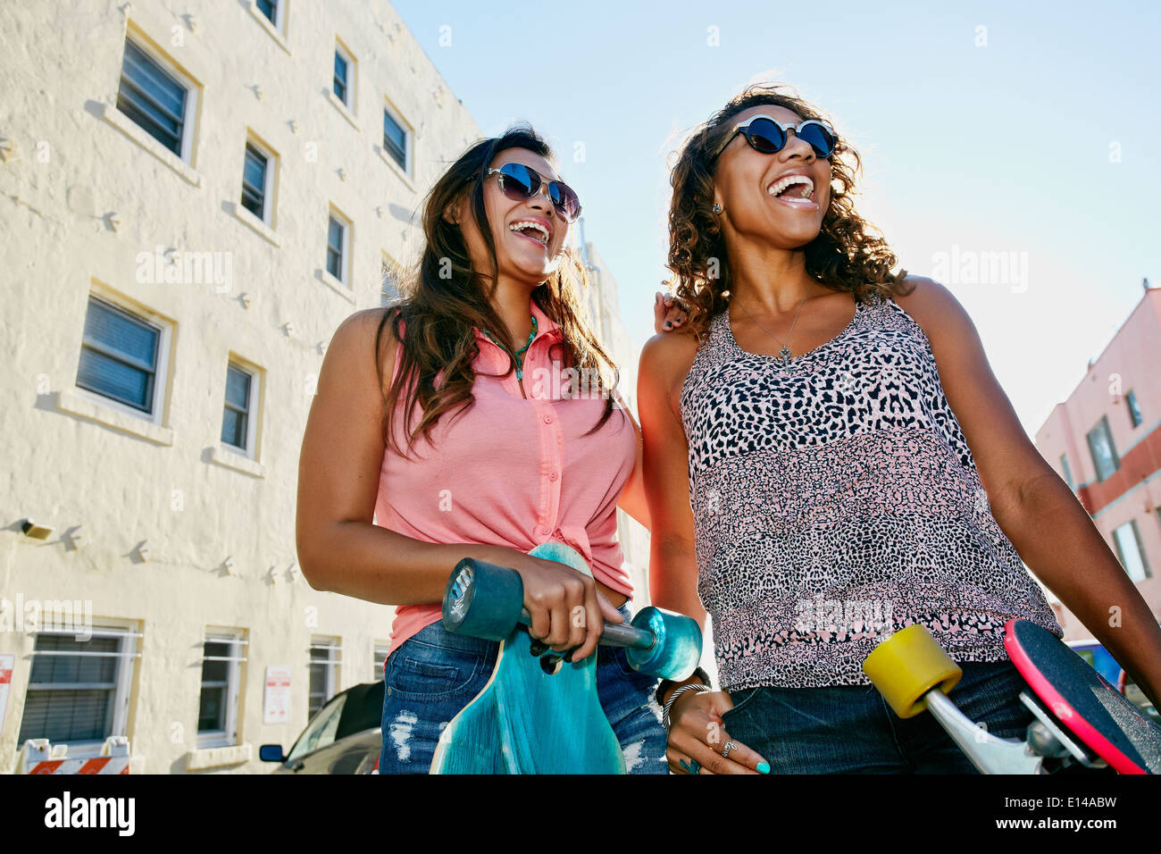 Women laughing on city street Stock Photo