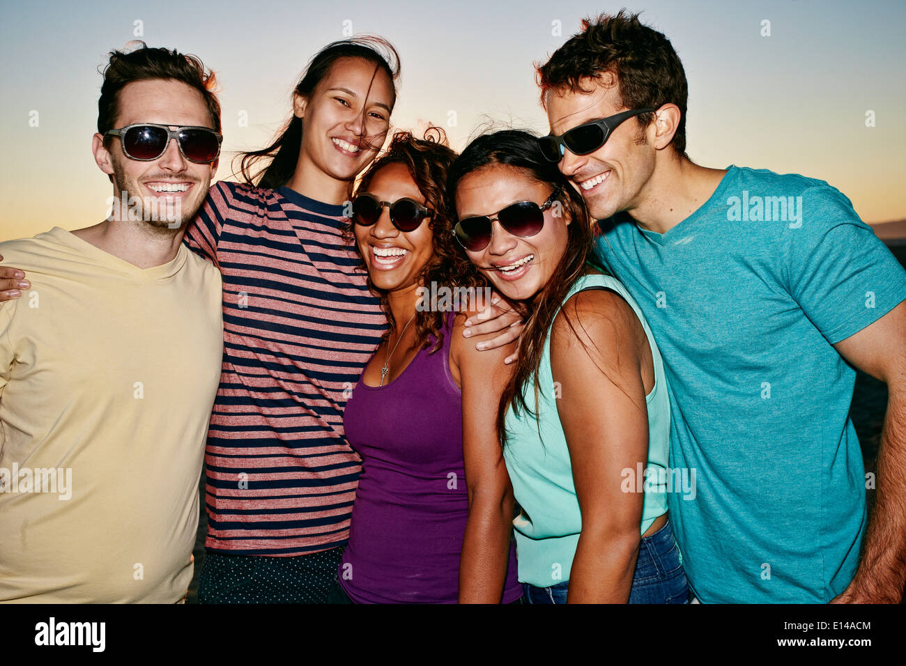 Friends smiling together on beach Stock Photo - Alamy