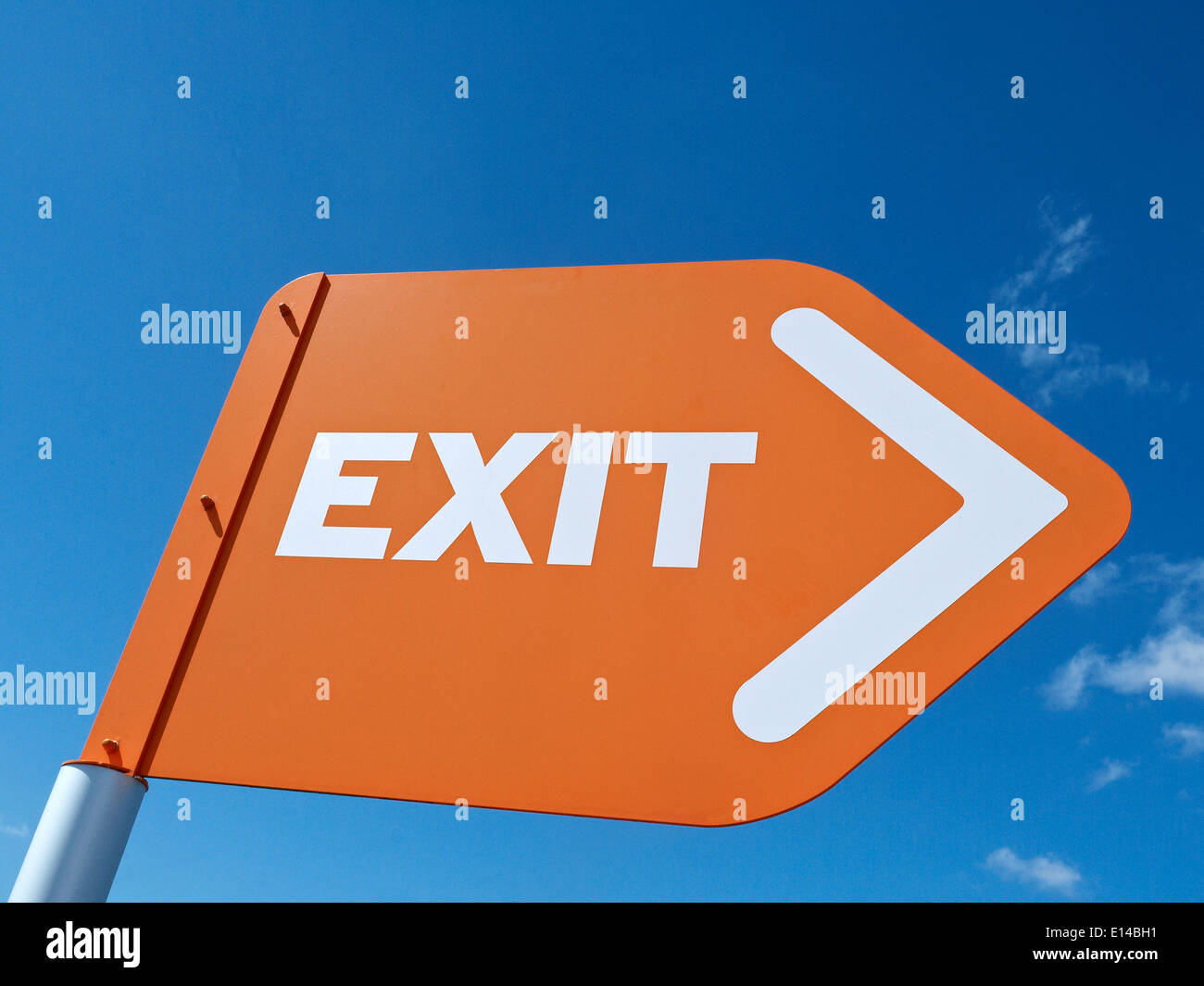 Exit sign isolated against blue sky UK Stock Photo