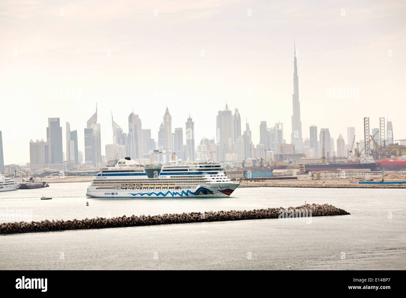 United Arab Emirates, Dubai, Financial city center skyline with Burj Khalifa, highest building in the world. Cruise ship Aida Stock Photo