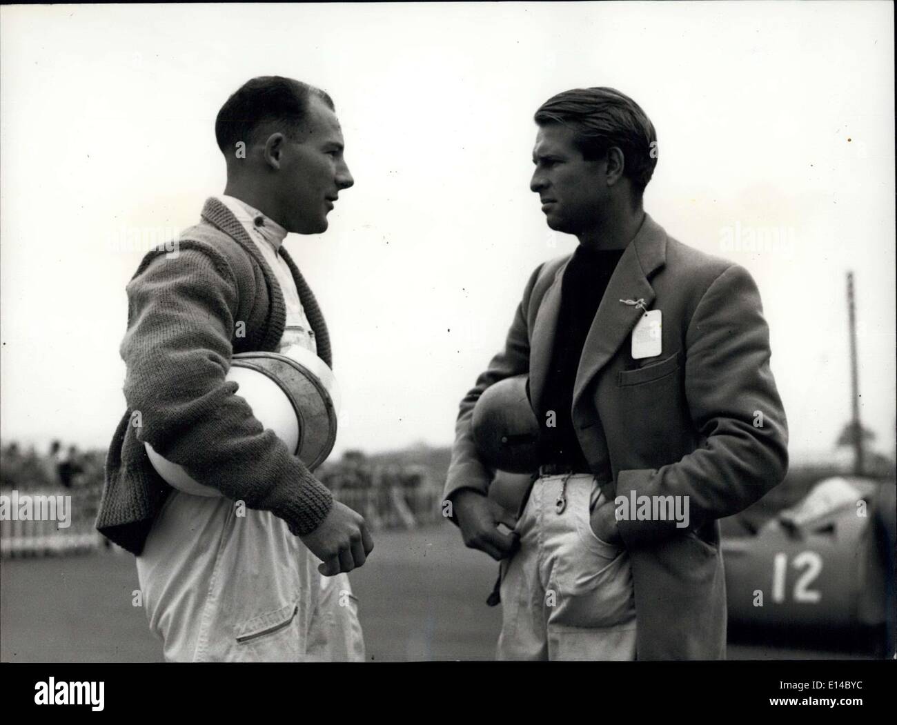 Apr. 17, 2012 - Friendly rivals. Both armed with their crass helmets, Peter Collins (right) and Stirling Moss, have a chat before the Grand Prix at Silverstone in which they both competed. Stock Photo