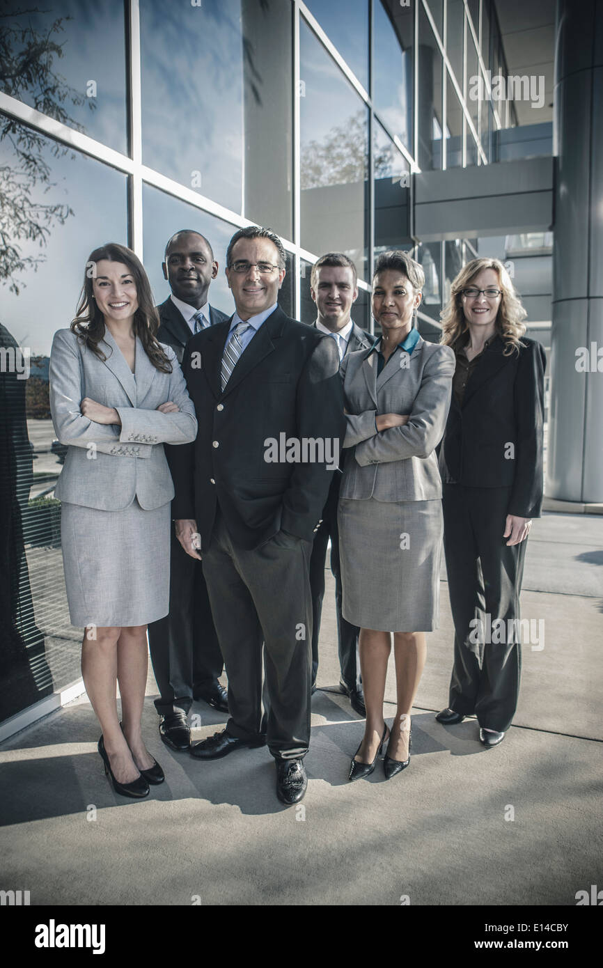 Business people smiling outside office building Stock Photo - Alamy