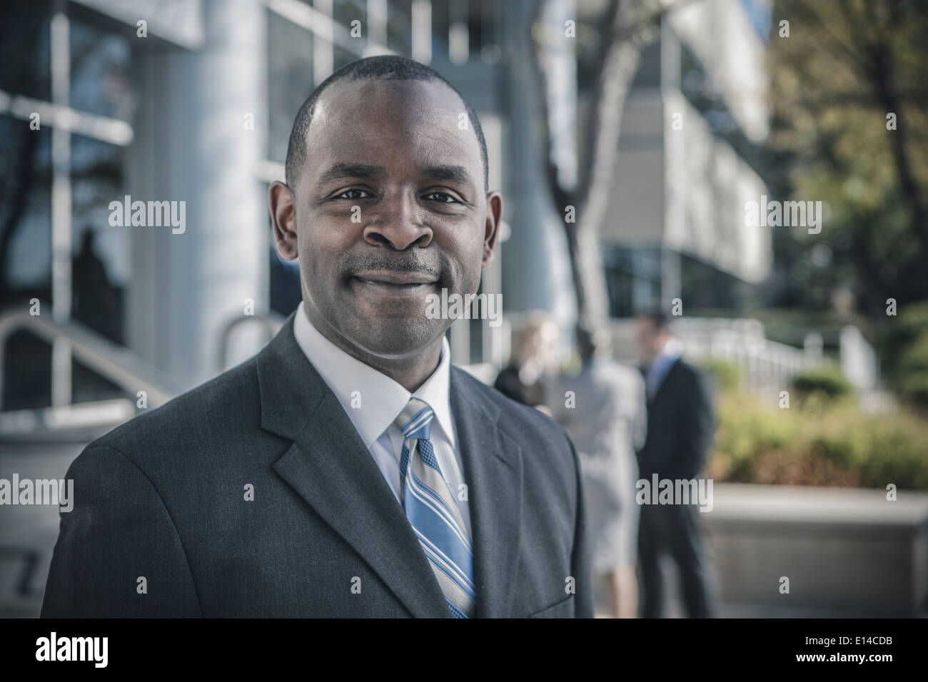 Businessman smiling outdoors Stock Photo - Alamy