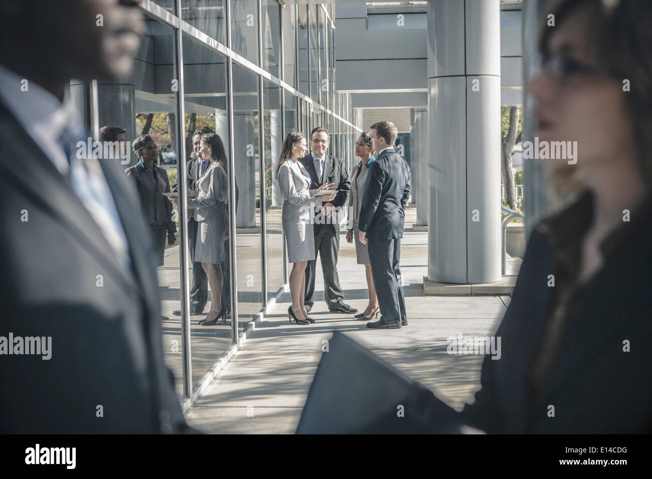 Business people talking outside office building Stock Photo