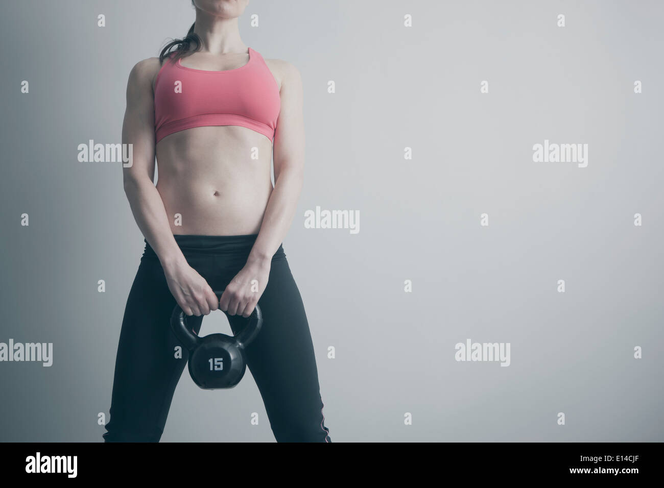Caucasian woman holding kettle bell Stock Photo