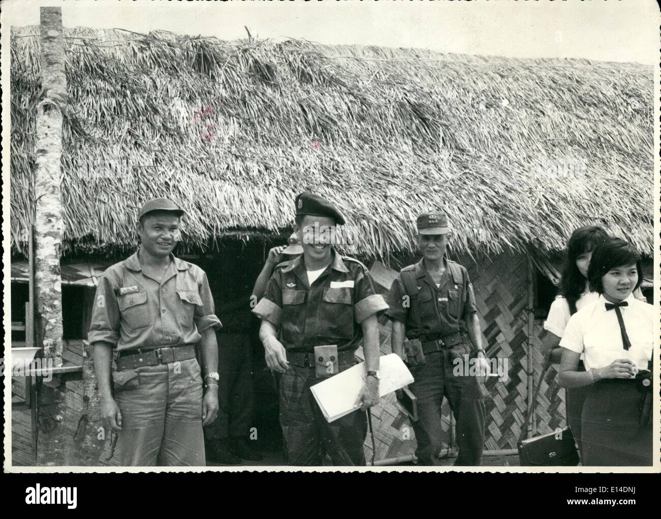 Apr. 18, 2012 - Commander of Lao battalion 33, a Lao belo colonel o colonel standing on the left, with South Vietnamese and a Vietnamese civic nation girl. Stock Photo