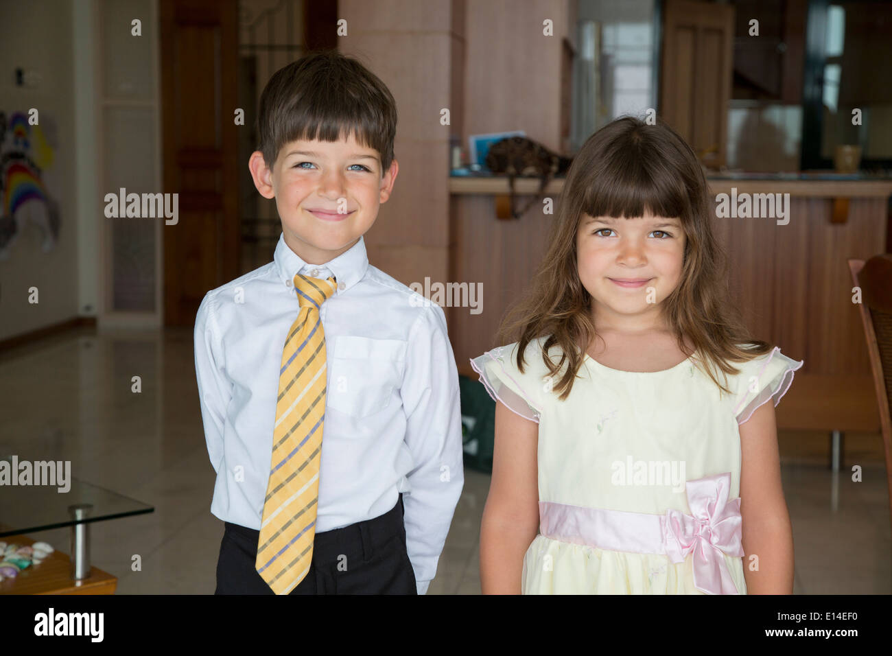 Caucasian children smiling in formal wear Stock Photo