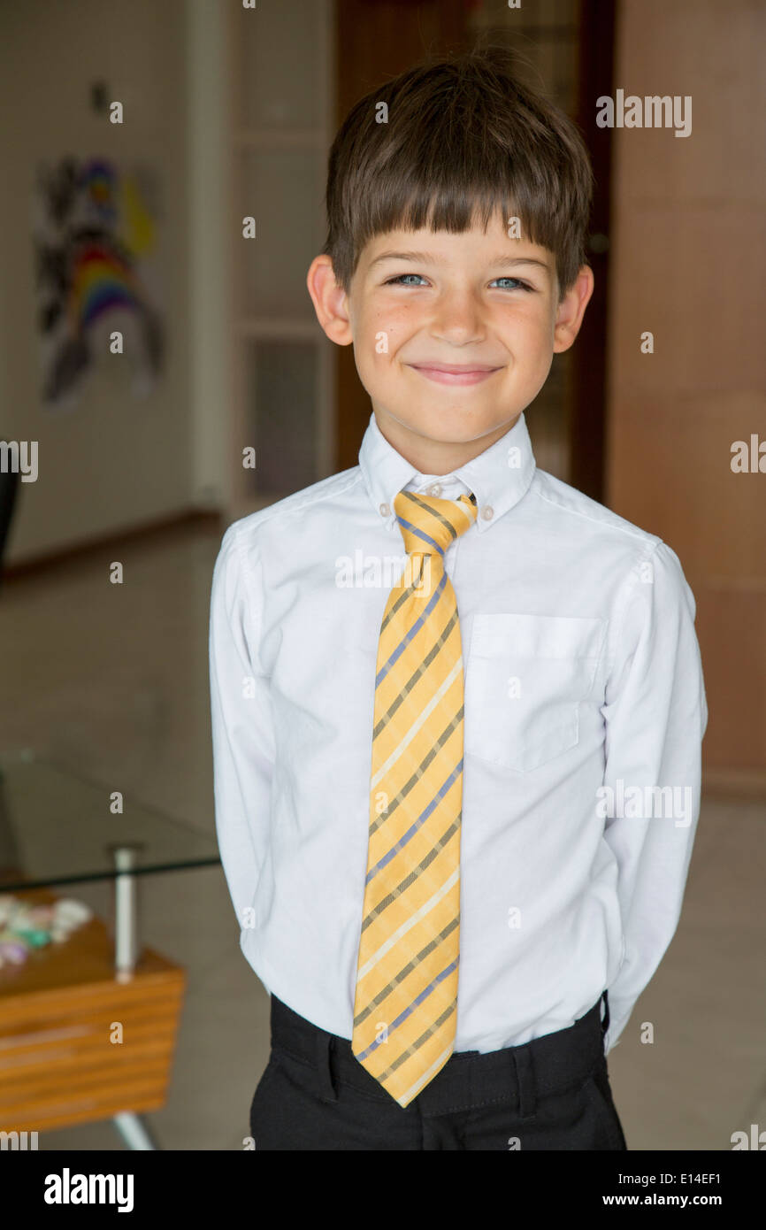 Caucasian boy smiling in formal wear Stock Photo