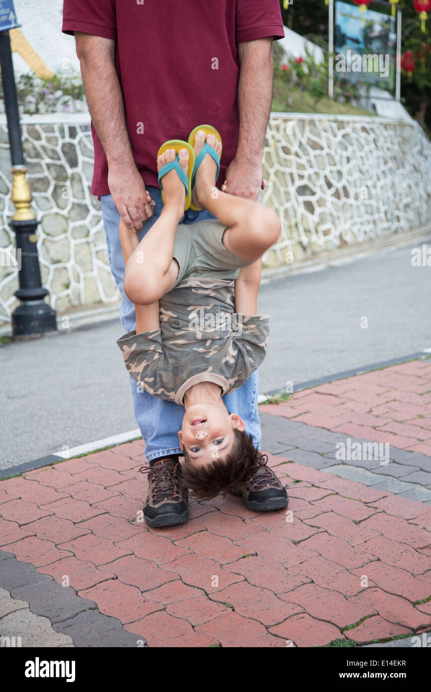 Caucasian father and son playing on city street Stock Photo