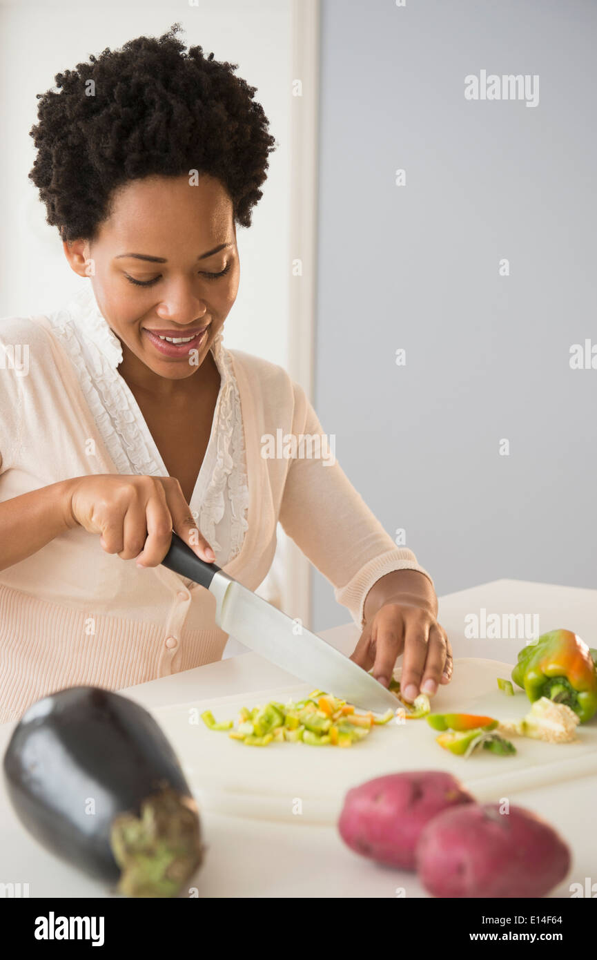 Black woman slicing vegetables Stock Photo
