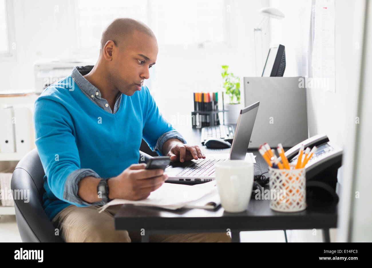 Black businessman working in office Stock Photo