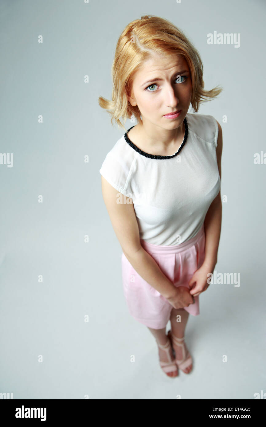 Compassionate young girl standing on gray background Stock Photo