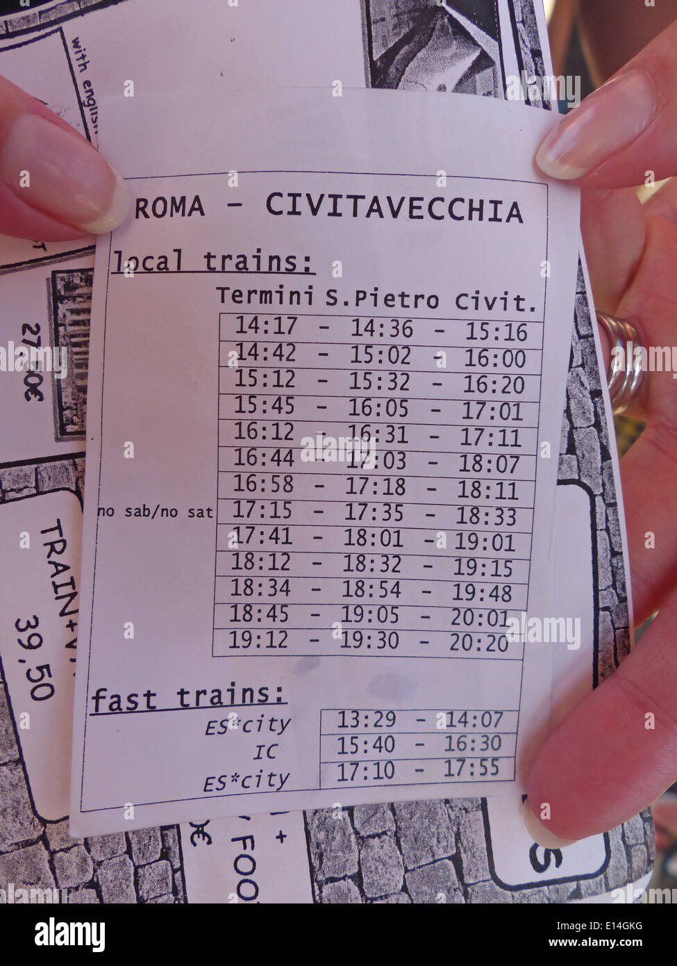 Hands holding a train timetable for Rome to Civitavecchia Stock Photo Alamy