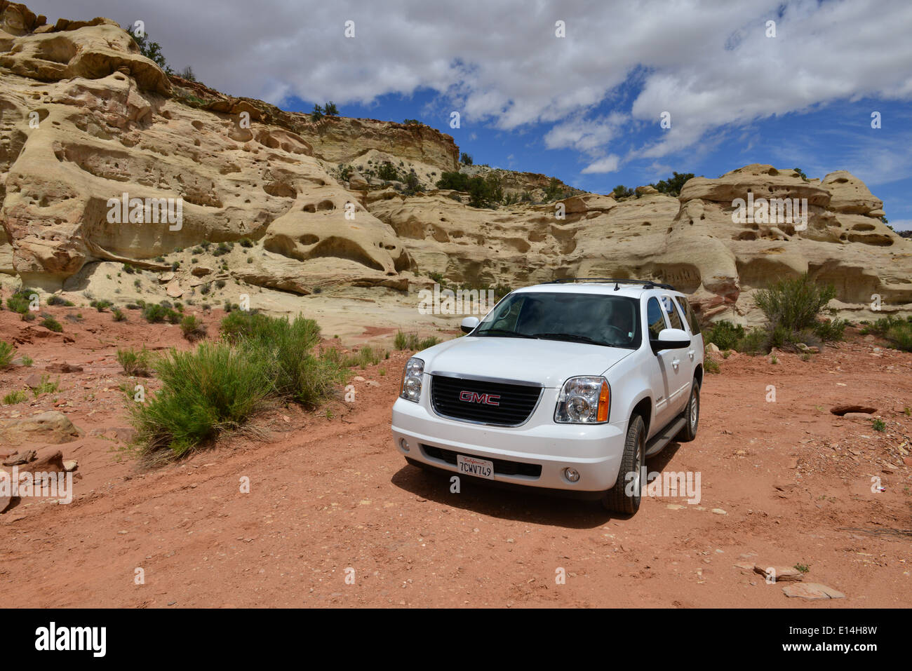 A white GMC Yukon in and around the Rock formations of Utah. Stock Photo
