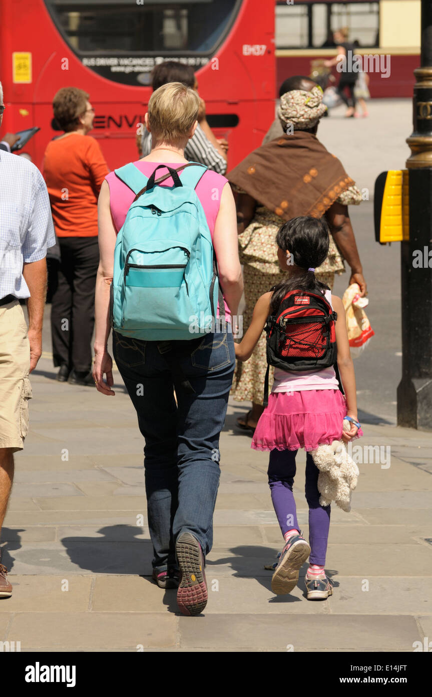 London, England, UK. Mother with young daughter carrying a soft toy in