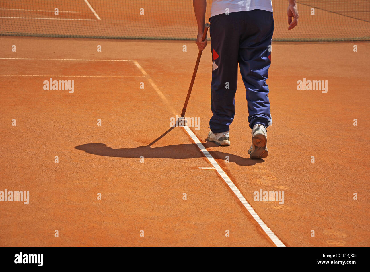 Cleaning the lines on a tennis court Stock Photo