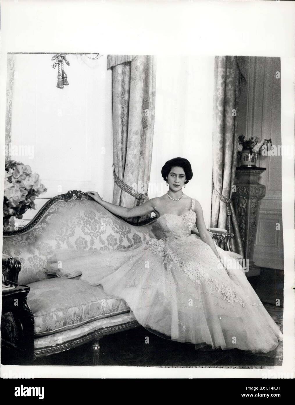 Apr. 05, 2012 - Princess Margaret 26. Princess Margaret, photographed by Cecil Beaton in the Drawing Room of Clarence House, her London residence. The photo was made in connection with Princess Margaret's 26th birthday on August 21. Her Royal Highness wears an evening dress of pink tulle embroidered with flowers and sequins. Her hair is worn short, softly waved, and piled high on her head. Stock Photo