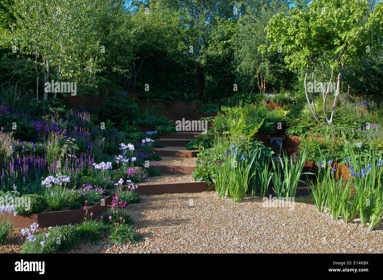 Terraces planted with alpines and herbaceous perennials in 'A Garden for First Touch at St. George's' at RHS Chelsea Flower Show Stock Photo