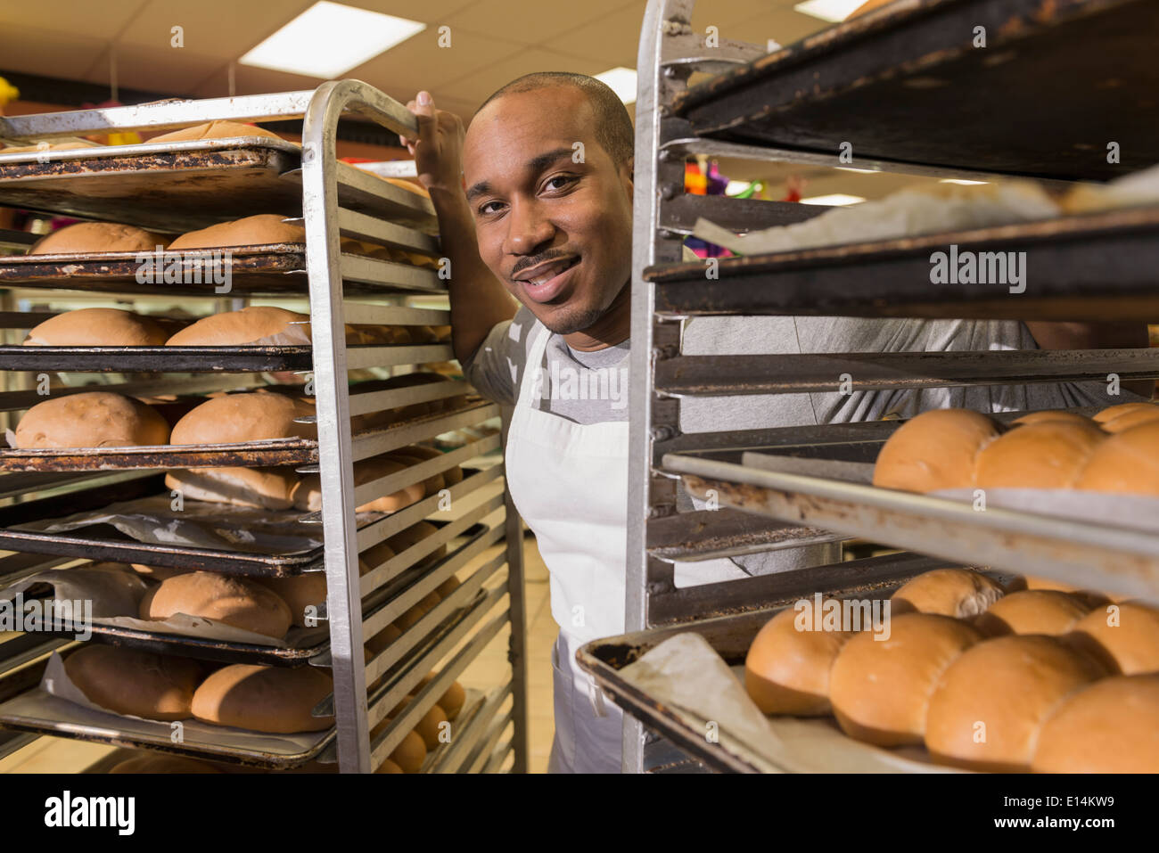 Black baker working in commercial kitchen Stock Photo