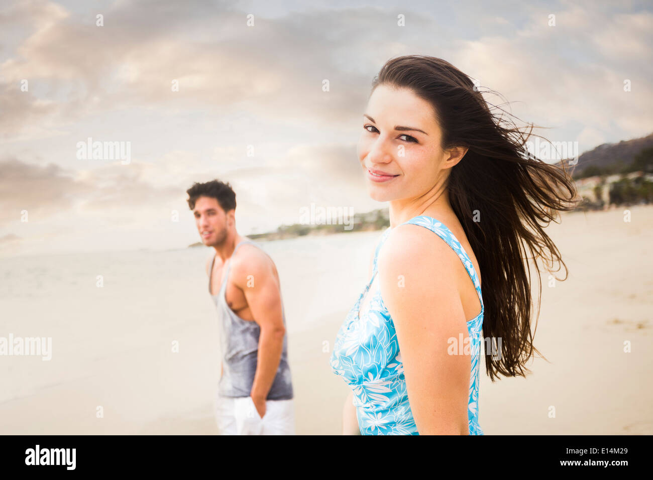 Caucasian couple walking on beach Stock Photo - Alamy