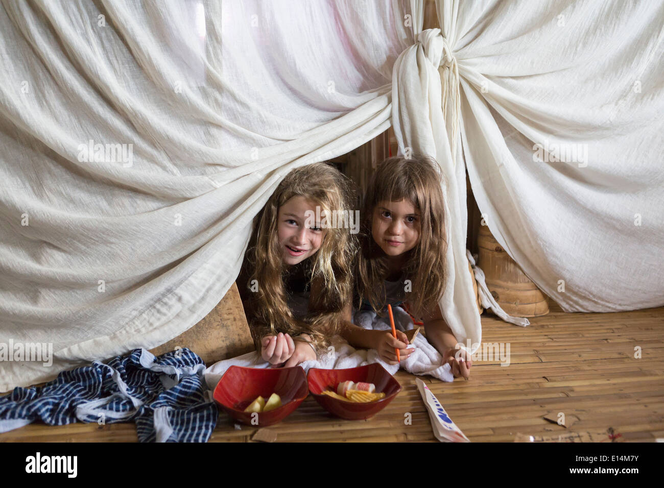 Caucasian girls playing in blanket fort Stock Photo Alamy