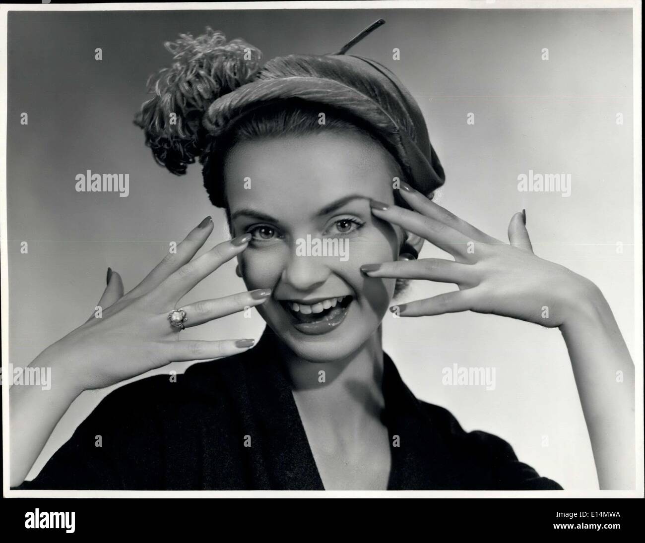 Apr. 05, 2012 - Youthful hat in cherry velvet ornamented with matching ostrich feather fronts and plume by Aage Thaarup who is making some of Queen Elizabeth's hats for her tour of Australia. Stock Photo