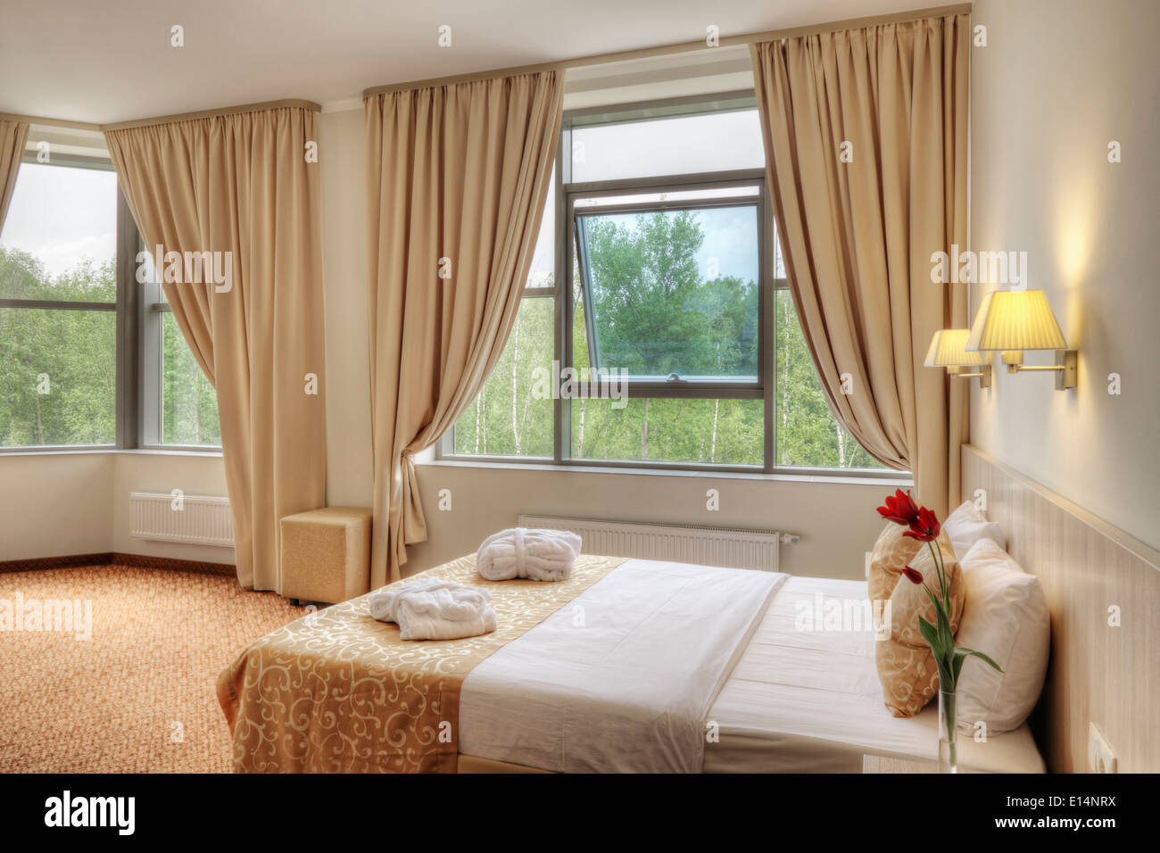 Bed and curtains in hotel room Stock Photo Alamy