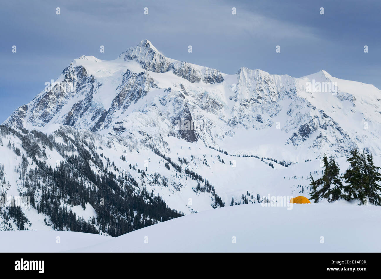 Rocky mountain overlooking snowy landscape Stock Photo