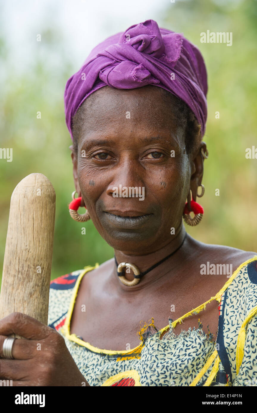 Fula woman holding a traditional pounding stick, the Gambia Stock Photo