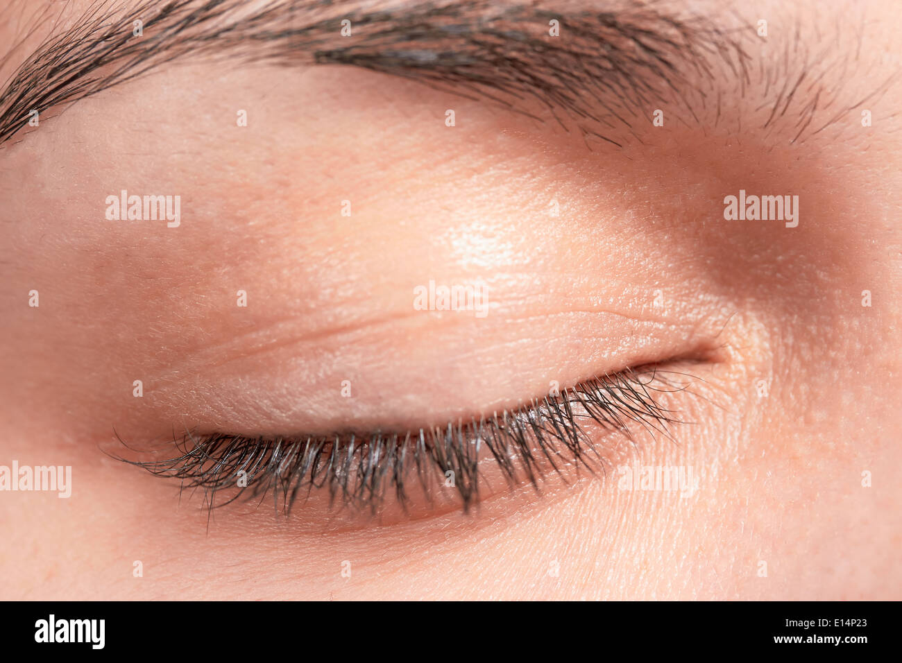 Closed female eye lashes closeup Stock Photo