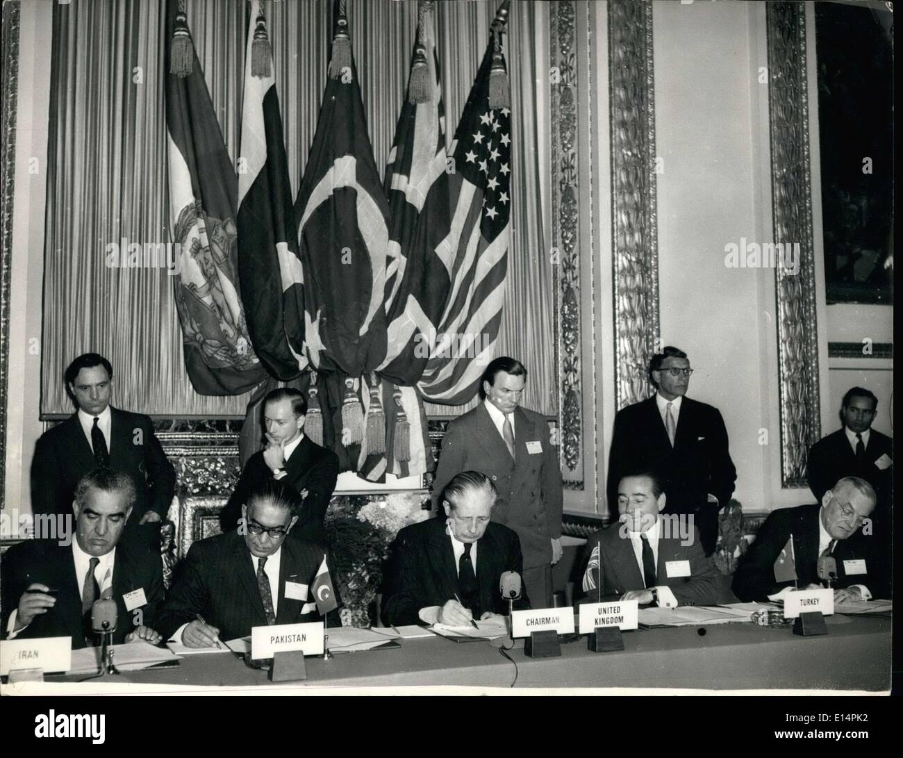 Apr. 12, 2012 - Bagdad Pact Council meeting at Lancaster House: Harold McMillan, John Foster Dulles pioning, the papers, ''(Illegible)'' (Turkish Prime Minister) in centre. Stock Photo