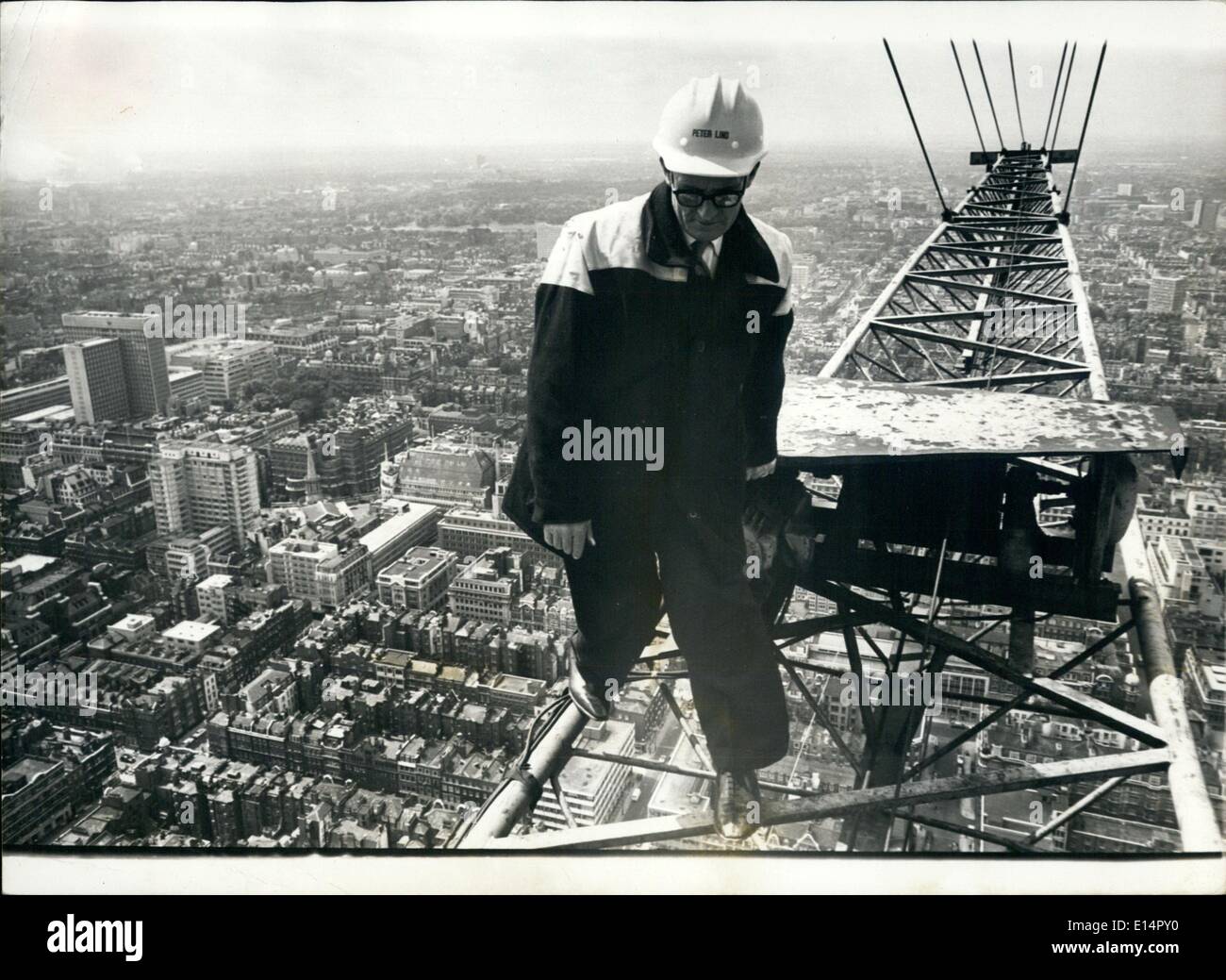 Apr. 18, 2012 - Ski-High Jim - The Man At The Top: With sure feet and a cool head, Jimmy Wheelan gets down to work - 635-feet up. As crane driver on the new Museum telephone exchange and radio tower off London Tottenham Court Road, he has the City's top job. Yesterday he reached the height of success - the topping out ceremony, which marked the completion of the structural work. For Jimmy, 52-year-old Irishman. It meant the end of a three -year-old job in which he has hoisted up 15,000-tons of comment, steel and glass Stock Photo