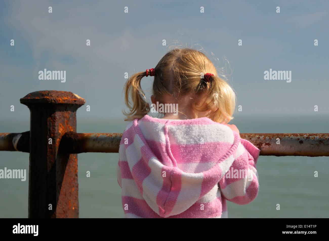 Young girl looking out to sea Stock Photo
