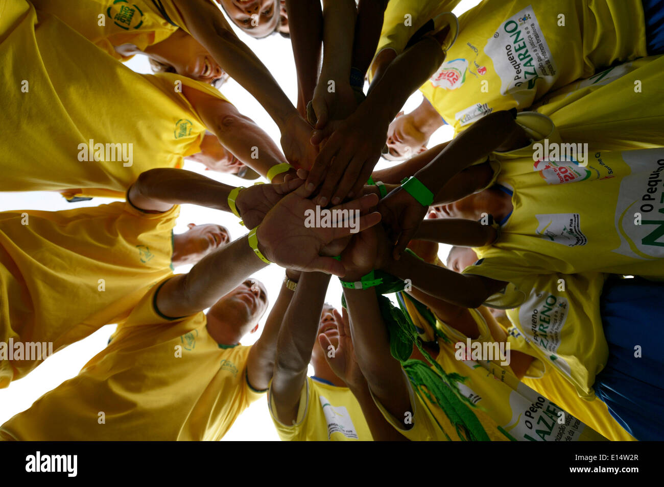 Soccer team motivating themselves in a circle before a game, Street Children World Cup 2014, Rio de Janeiro Stock Photo