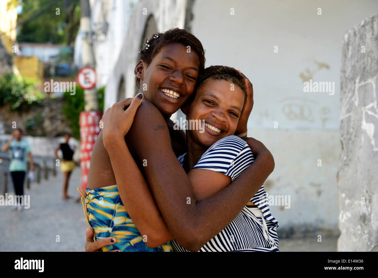Former street child, girl, 15, hugging her mother, Lapa district, Rio de Janeiro, Rio de Janeiro State, Brazil Stock Photo