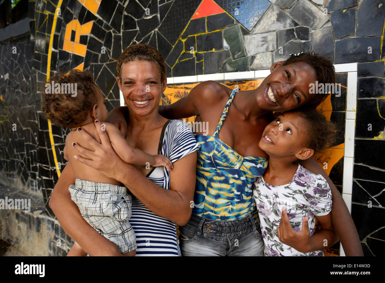 Former street child, girl, 15, hugging her mother and siblings, Lapa district, Rio de Janeiro, Rio de Janeiro State, Brazil Stock Photo