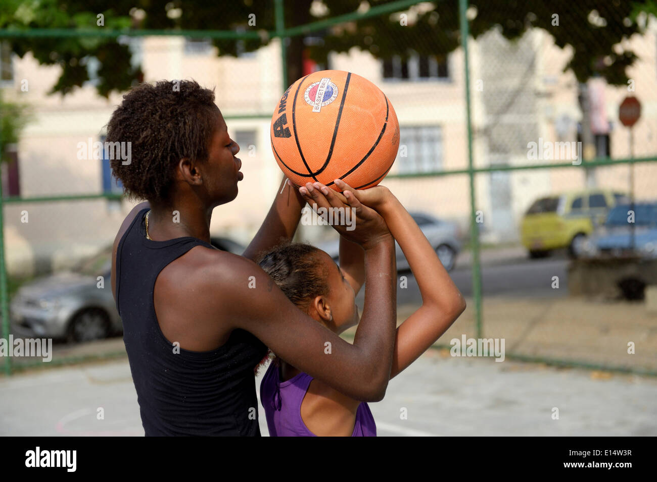 Two girls, 15 and 10, training basketball, Rio de Janeiro, Rio de Janeiro State, Brazil Stock Photo