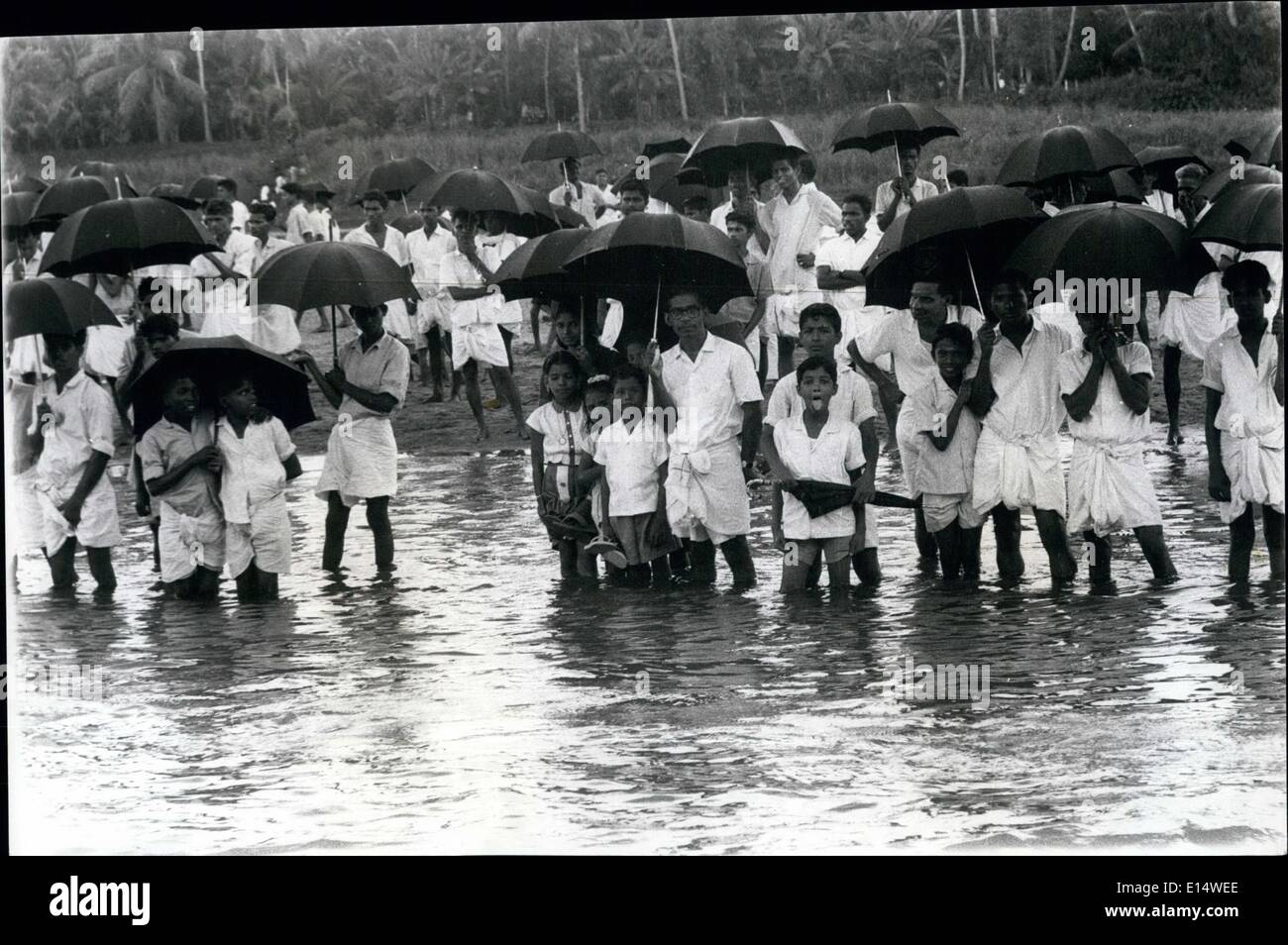 Apr. 18, 2012 - Harvest Festivl in the land of Kerala Celebrates on water. Villagers of the area now wear a mixture of western and local attire, but carry umbrellas to keep their heads dry but don't worry about the river water washing their feet as they watch the Aranmula Boat Festival in Kerals Stock Photo