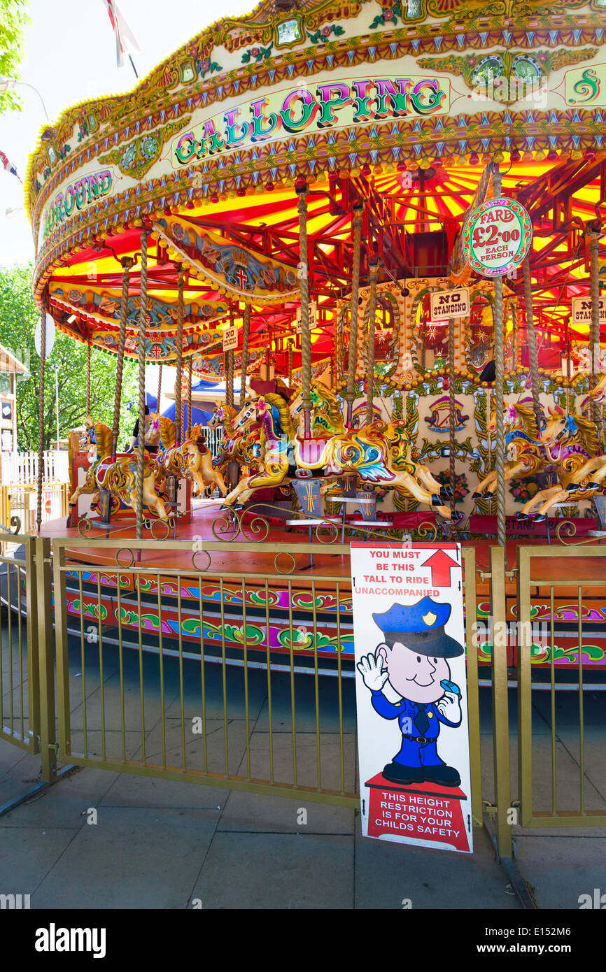 Minimum height sign on traditional carousel fair ground ride. Stock Photo