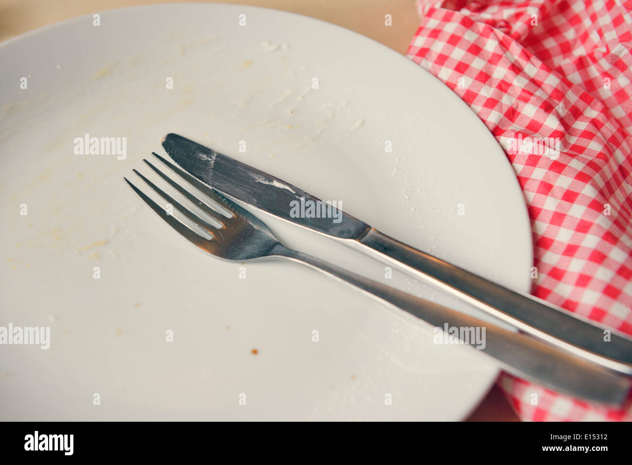 Empty plate with fork and knife Stock Photo - Alamy