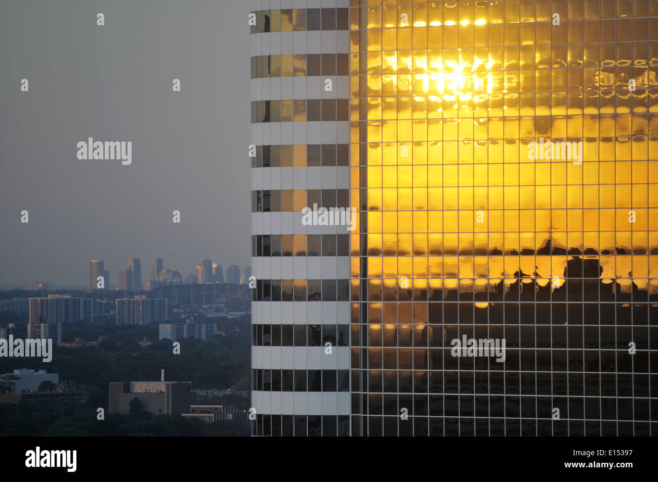 Setting sun reflected in the glass facade of a skyscraper in Toronto