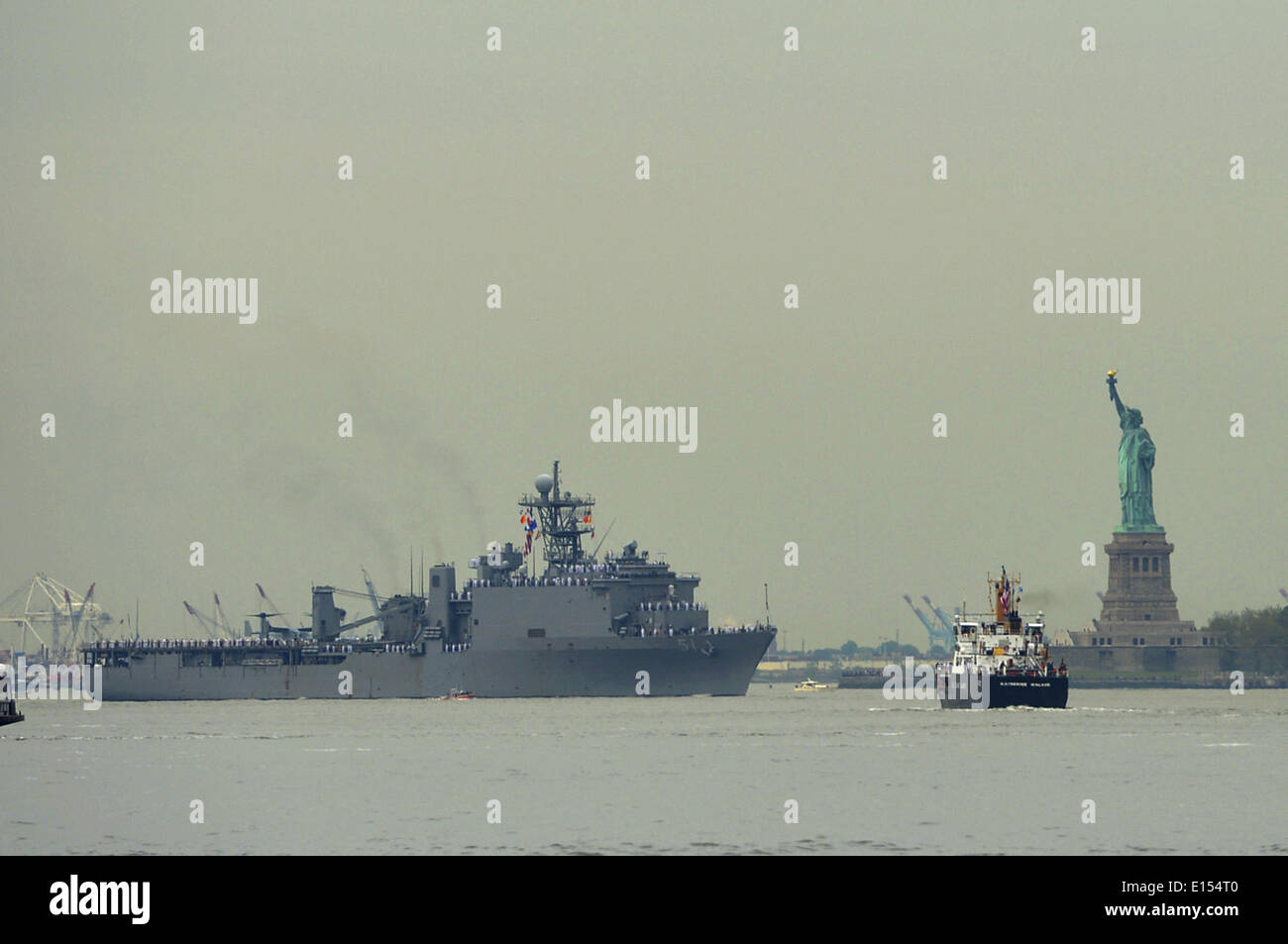 New York, USA. 21st May, 2014. The USS Oak Hill passes the Statue of Liberty during the parade of fleet week, in New York, the United States, on May 21, 2014. Credit:  Wang Lei/Xinhua/Alamy Live News Stock Photo