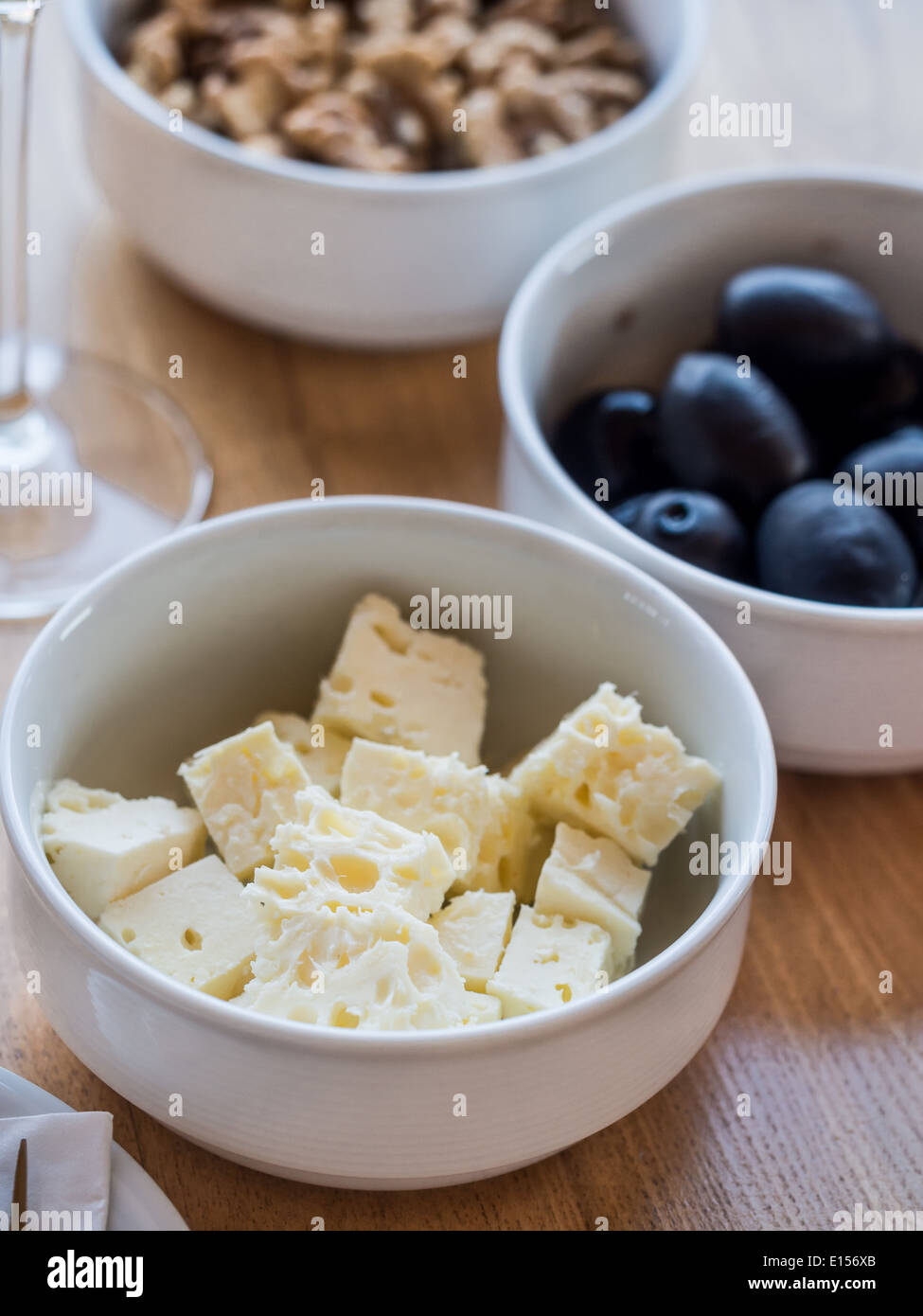 Local sheep cheese, nuts and olives served with wine tasting in one of the cellars in Kakheti wine region, Georgia, Caucasus. Stock Photo