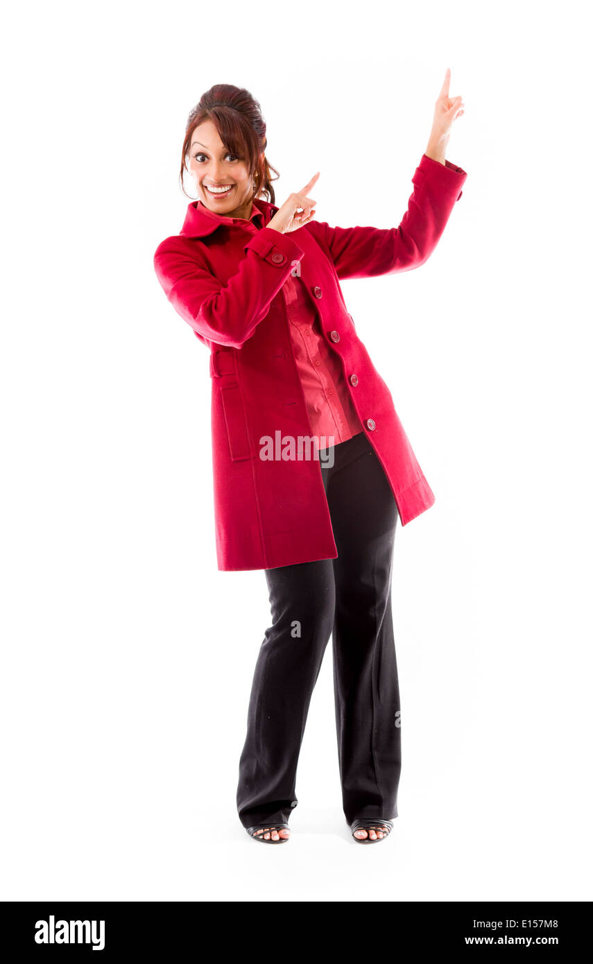 Indian young woman pointing upward and smiling Stock Photo