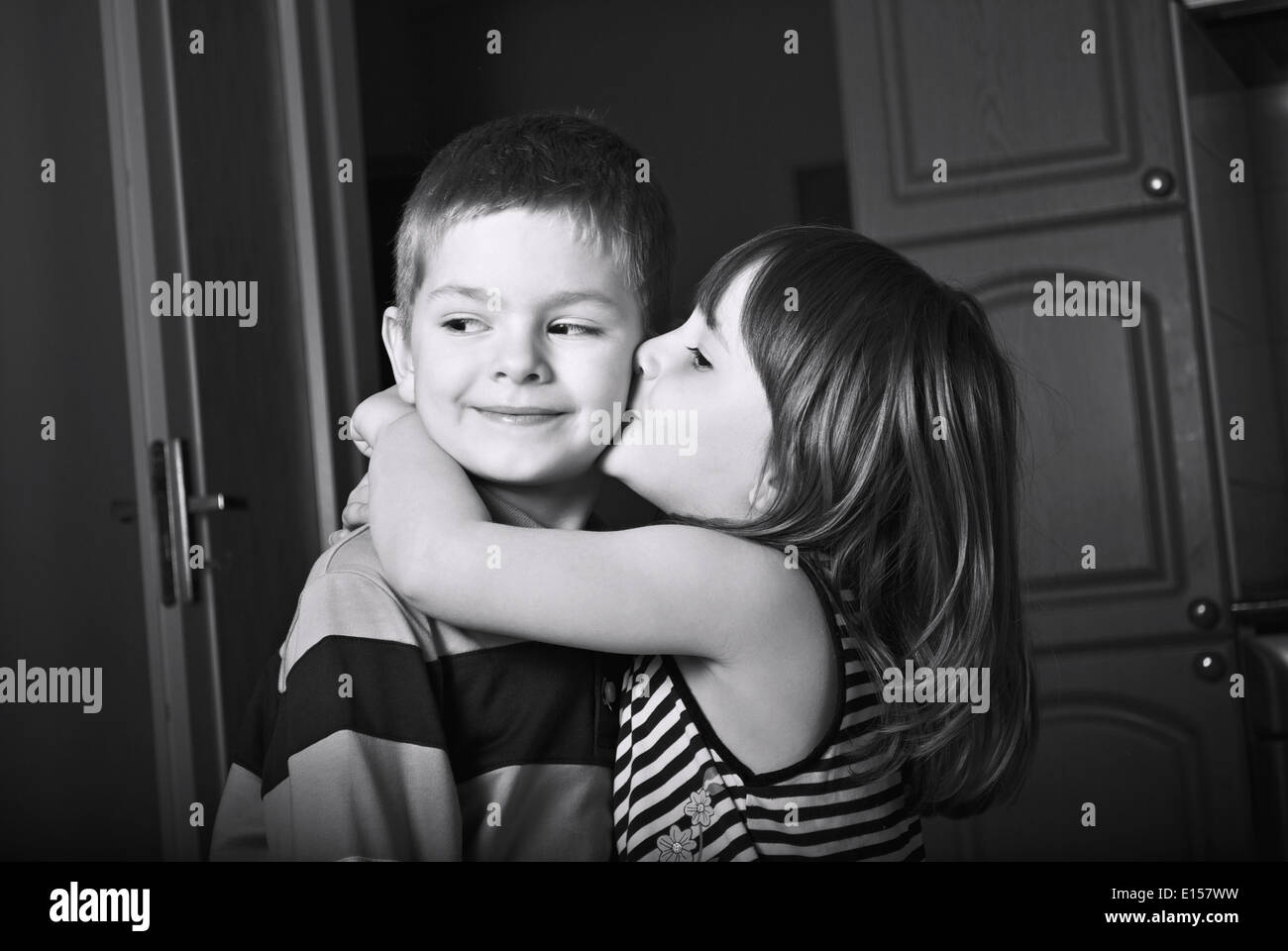 Adorable little girl kissing a boy Stock Photo