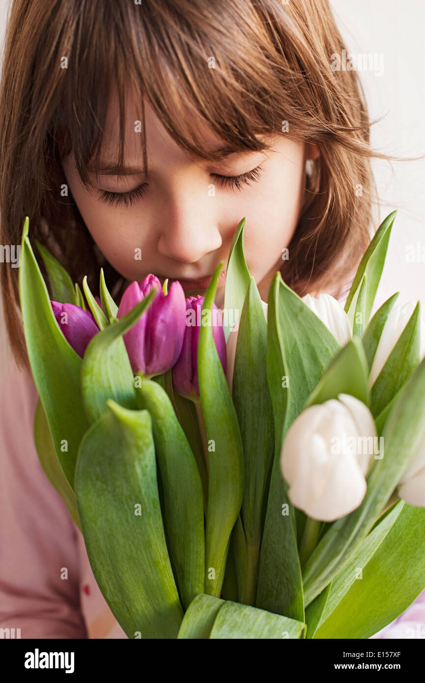 Adorable little girl with bouquet of tulips Stock Photo