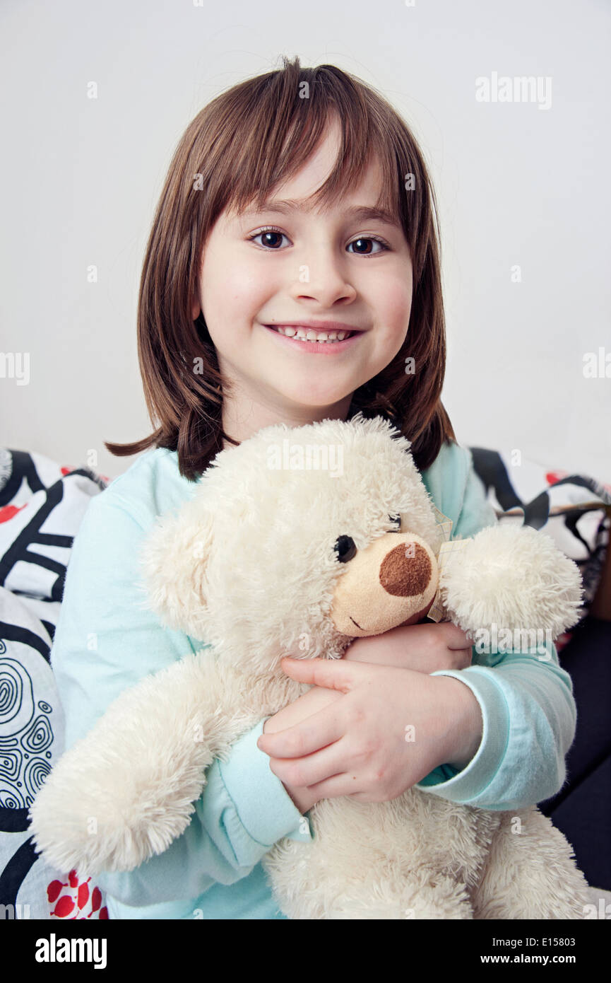 Portrait of little girl smiling with teddy bear Stock Photo