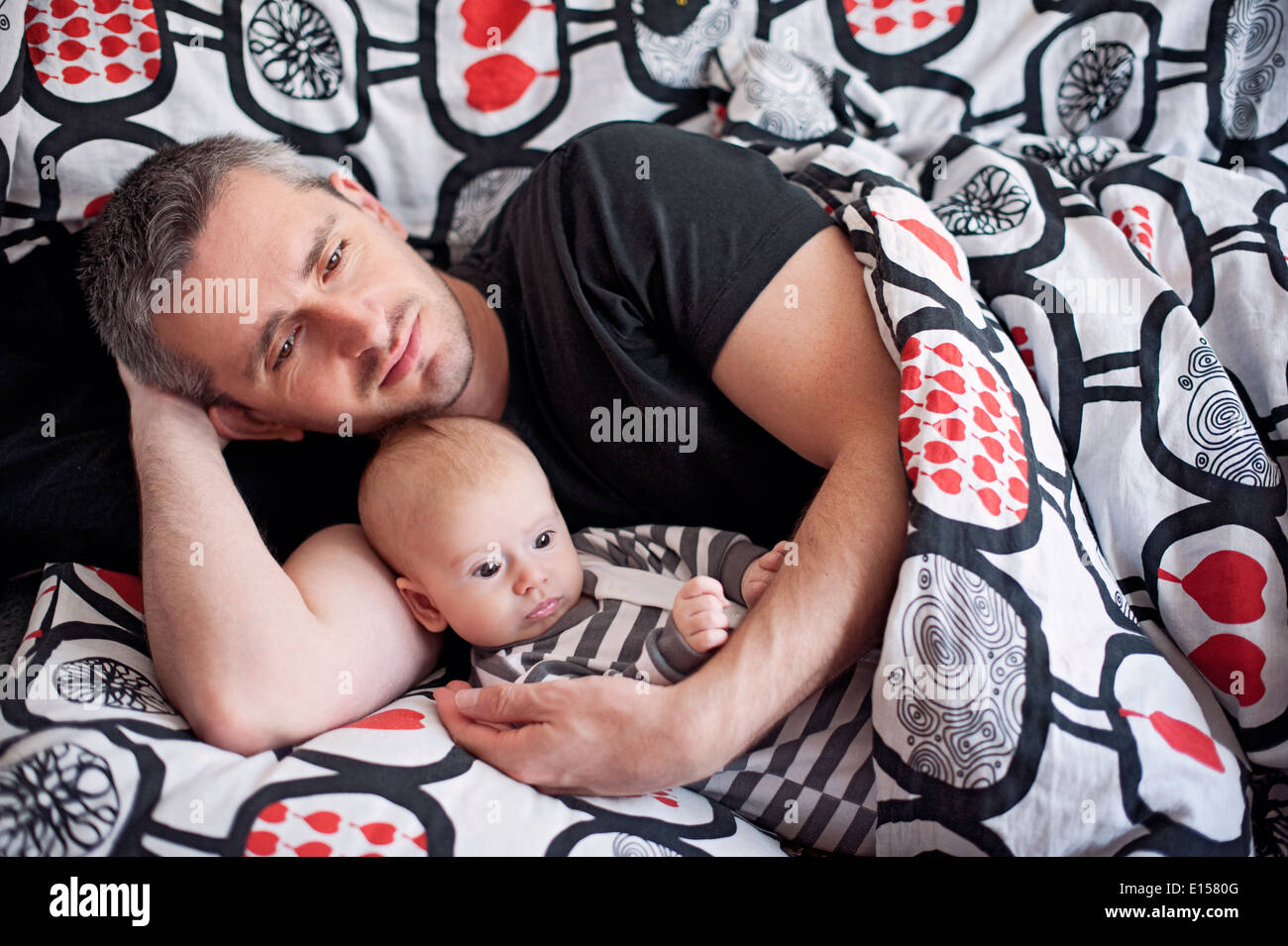 Father and newborn daughter resting Stock Photo